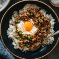 Cantonese Mince Beef Rice and Eggs | A super easy Cantonese minced beef bowl cooked with an oyster-sauce-based sauce, onion, green peas, and runny eggs. Top it on steamed rice or noodles to make a hearty and healthy meal. It’s also perfect to make ahead and use as meal-prep. {Gluten-Free Adaptable}