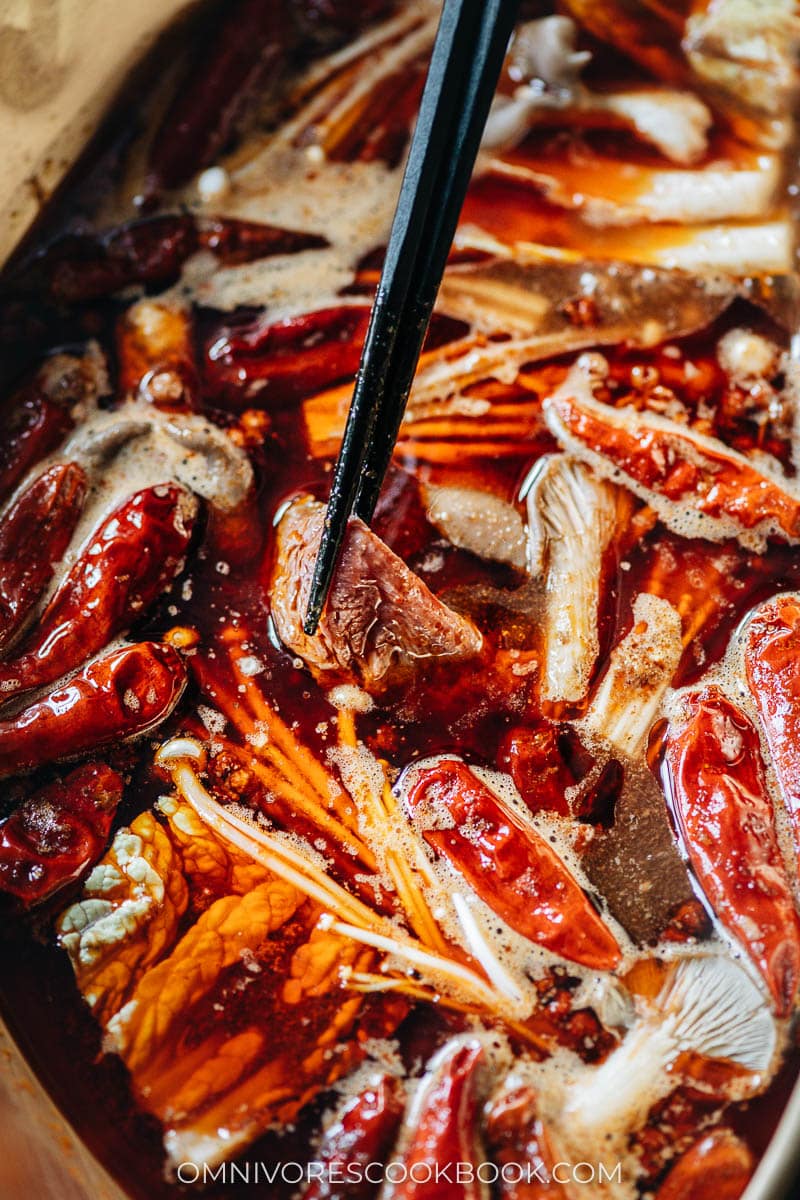 Dipping meat in Sichuan hot pot