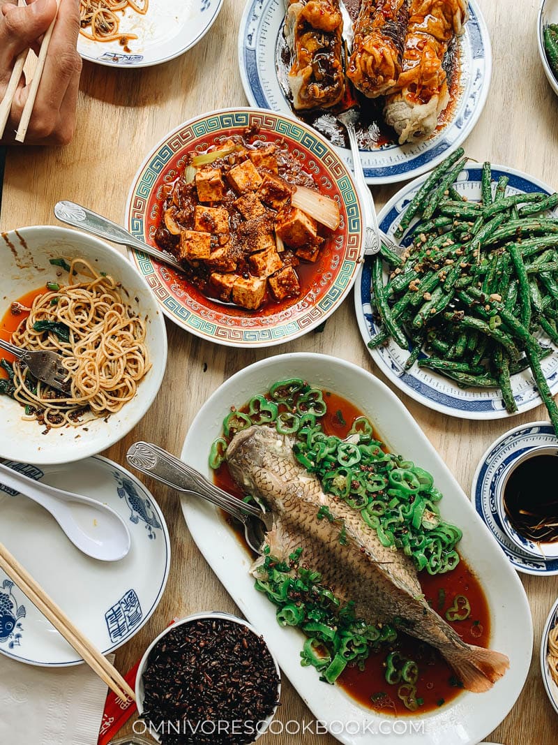 A Sichuan Chinese dinner spread with whole fish, mapo tofu, green beans, and eggplant at Birds of a Feather