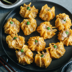 Cantonese shumai are fresh, juicy pork and shrimp filled dumplings with thin, bright yellow wrappers. Learn how to make shumai like the ones at a dim sum shop.
